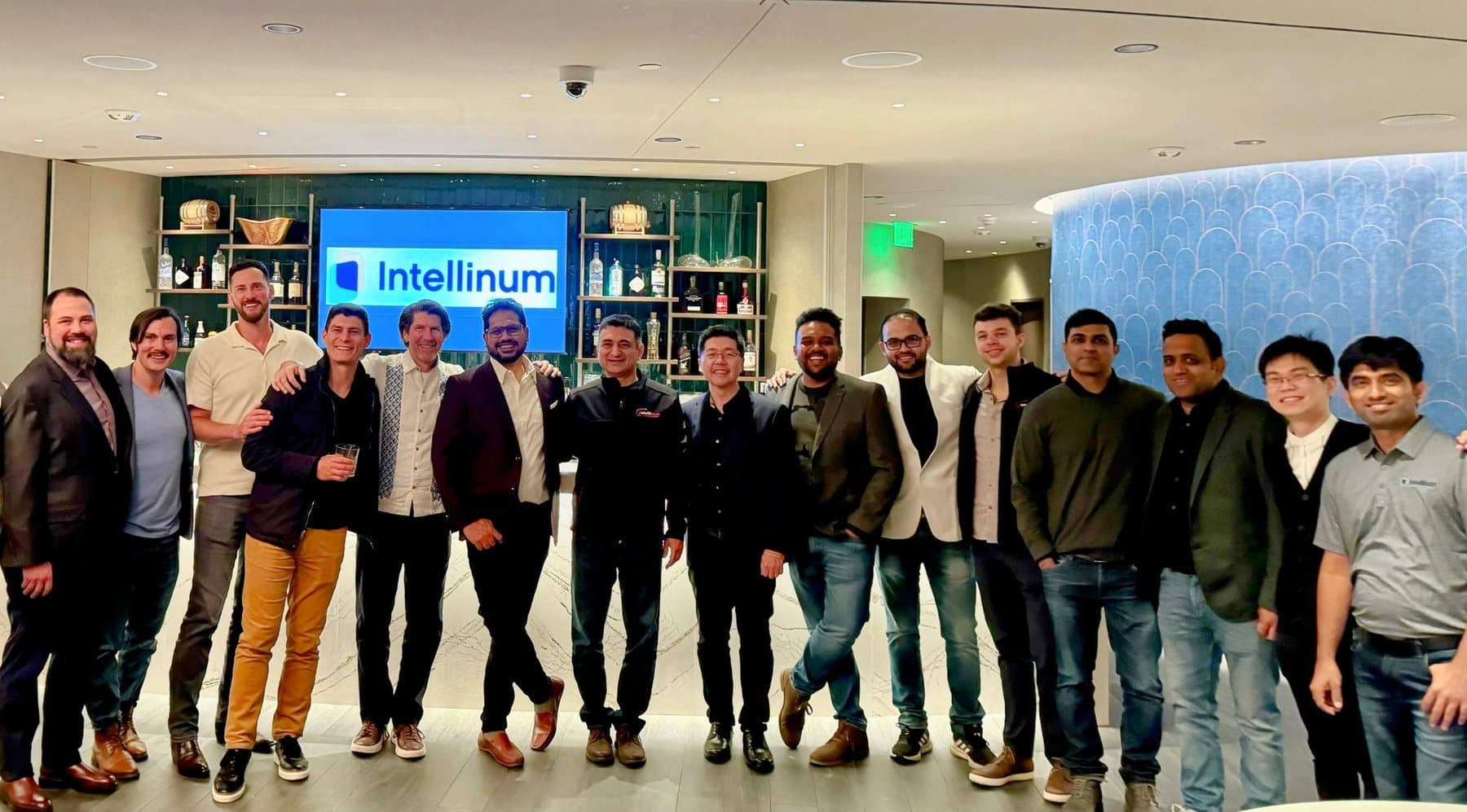 The Intellinum team together in front of an Intellinum-branded screen