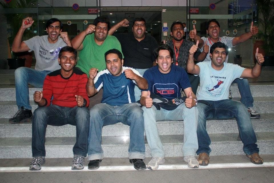 Oracle product development football team celebrating together on a flight of steps